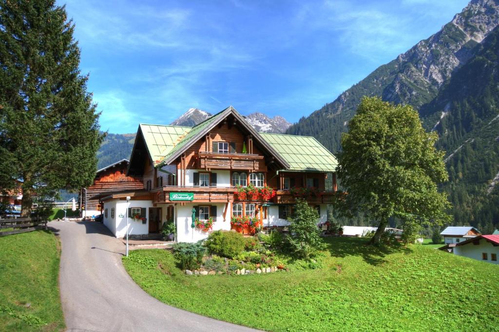 a house on a hill with a winding road at Bödmerhof in Mittelberg