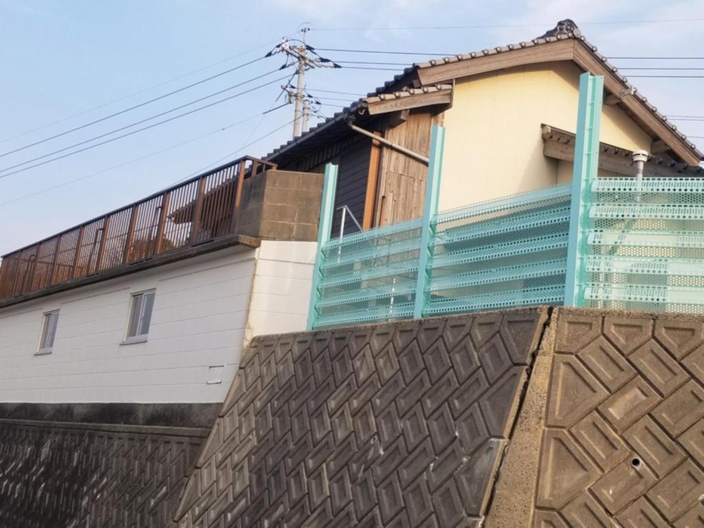 ein Haus auf einer Mauer in der Unterkunft コンドミニアム海のまんまえ荘 in Kangoji