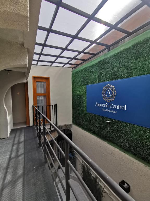 a hallway with a sign on the wall of a building at Alquería Central hotel in Tlaxco de Morelos