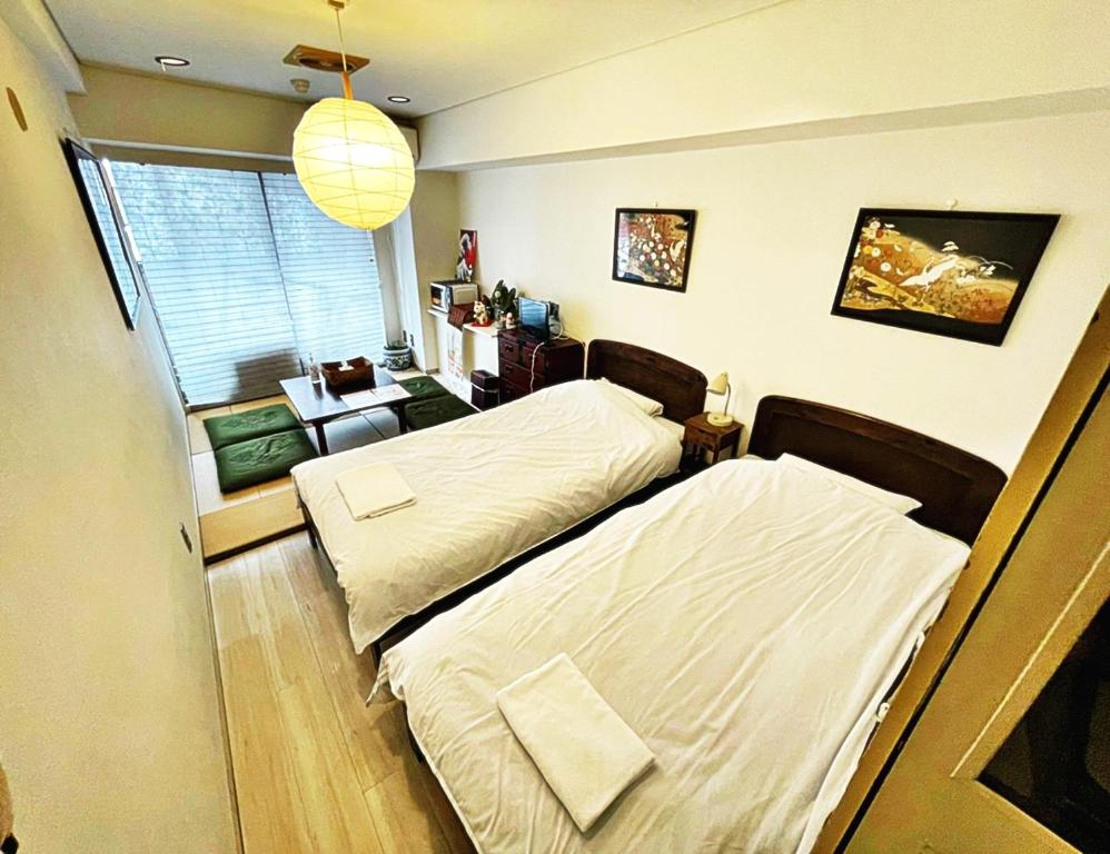 a bedroom with two beds and a window at ☆Cozy Japanese style room☆ in Tokyo