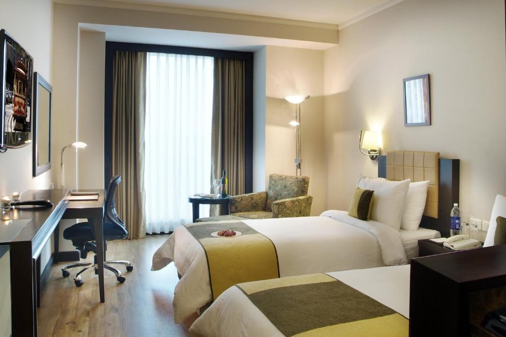 Postel nebo postele na pokoji v ubytování Goldfinch Hotel Delhi NCR
