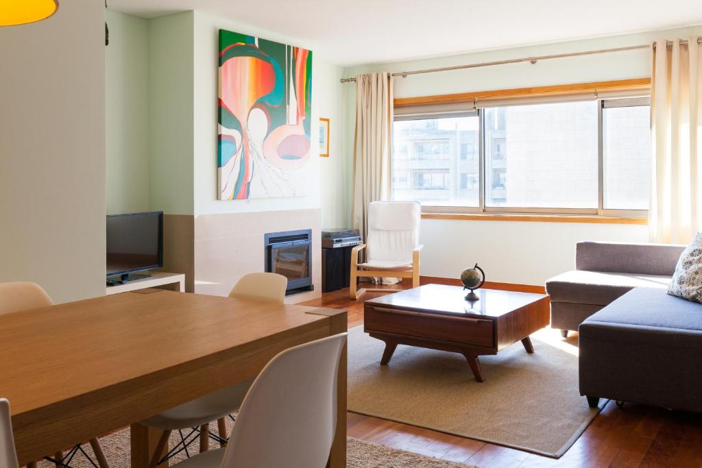 a living room with a couch and a table at The Refreshing Seaside Home in Matosinhos