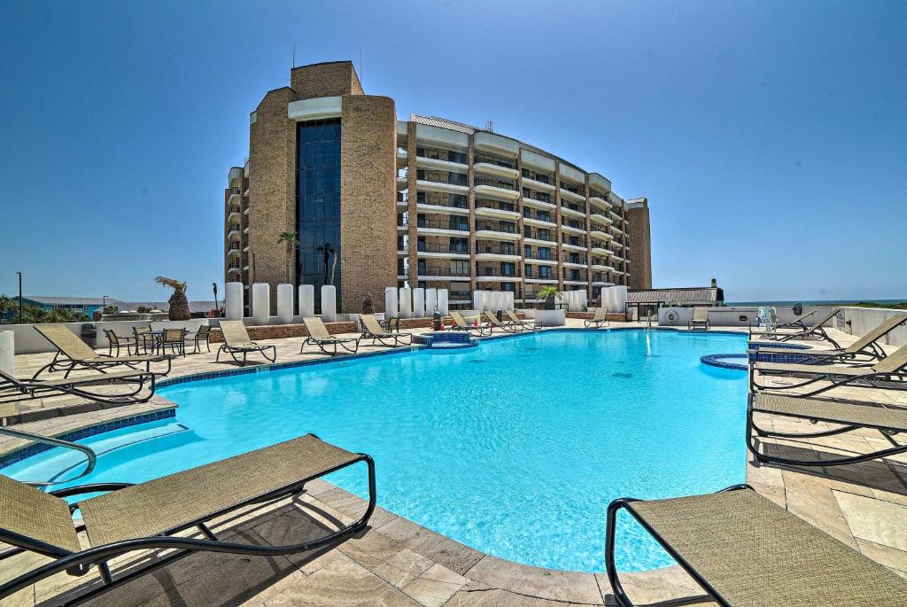 a large swimming pool with chairs and a hotel at Waterfront Port Aransas Condo with Beach Access! in Port Aransas