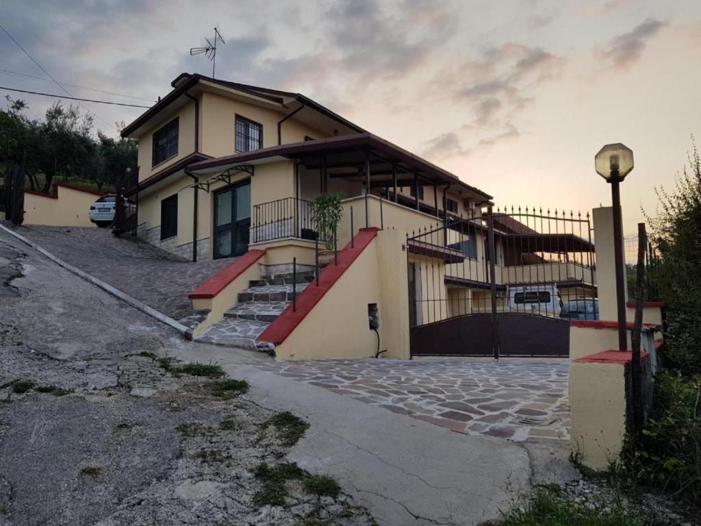 a house with stairs in front of it at Appartamento con solo camera e bagno senza cucina in Casale