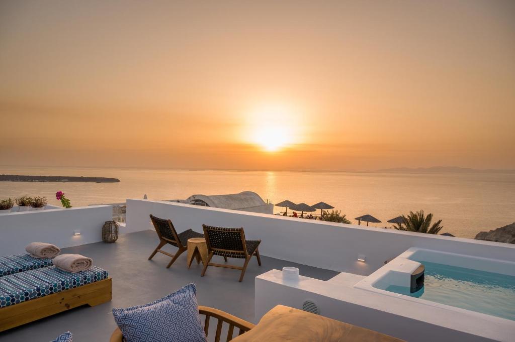 a villa with a view of the ocean at sunset at Cape Suite Oia in Oia