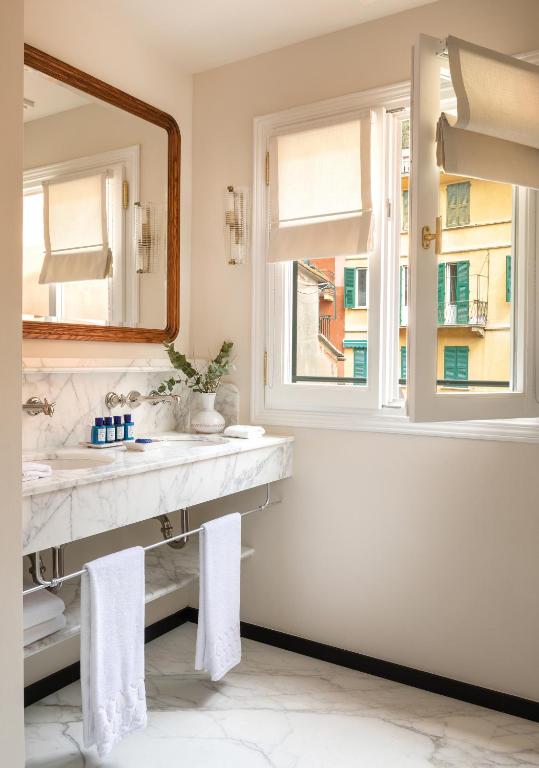 a bathroom with a sink and a mirror at Splendido Mare, A Belmond Hotel, Portofino in Portofino
