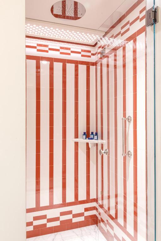 a bathroom with a shower with red and white stripes at Splendido Mare, A Belmond Hotel, Portofino in Portofino