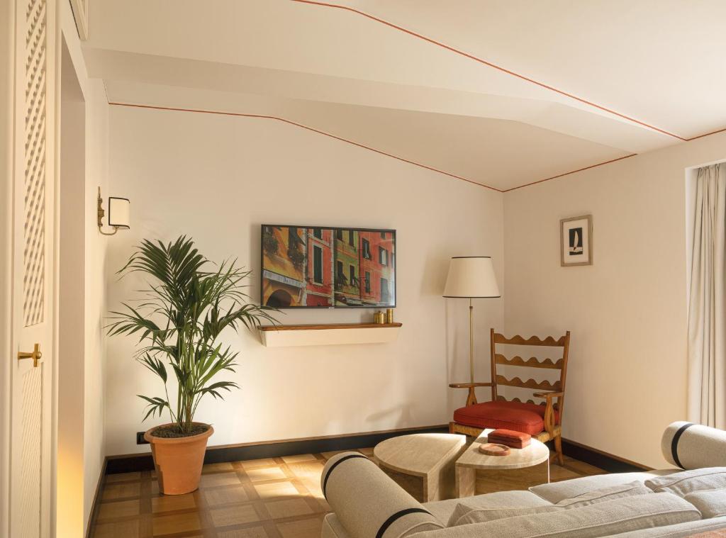 a living room with a couch and a plant at Splendido Mare, A Belmond Hotel, Portofino in Portofino