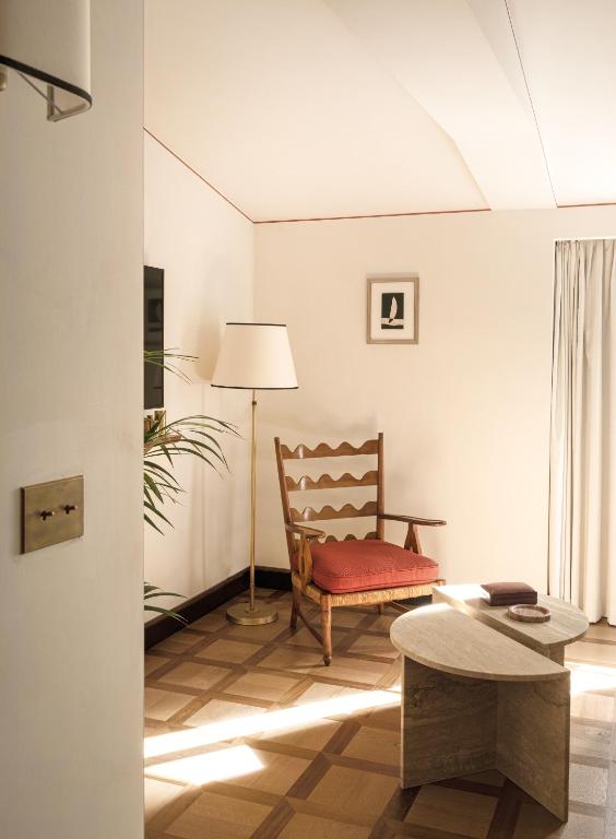 a living room with a chair and a table at Splendido Mare, A Belmond Hotel, Portofino in Portofino
