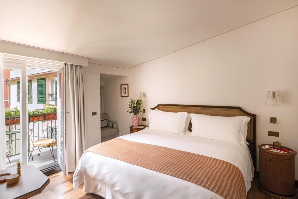 a bedroom with a large bed and a balcony at Splendido Mare, A Belmond Hotel, Portofino in Portofino