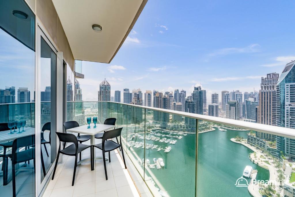 a balcony with a table and chairs and a view of the city at Dream Inn Dubai - Damac Heights Marina in Dubai