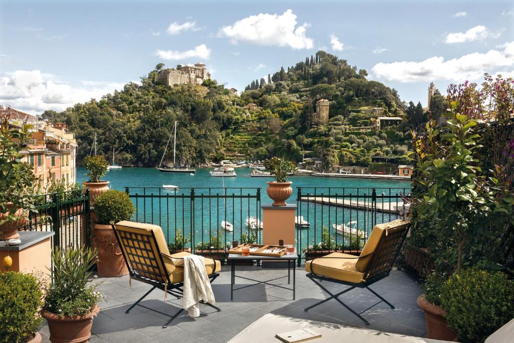 a balcony with chairs and a view of the water at Splendido Mare, A Belmond Hotel, Portofino in Portofino
