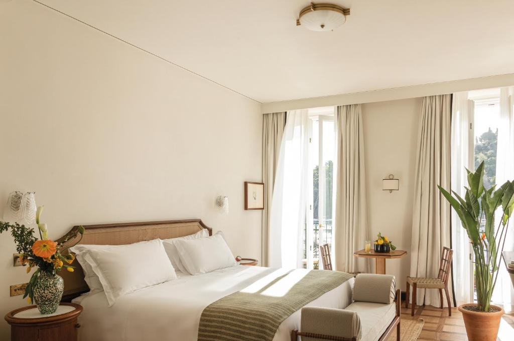 a hotel room with a bed and a window at Splendido Mare, A Belmond Hotel, Portofino in Portofino