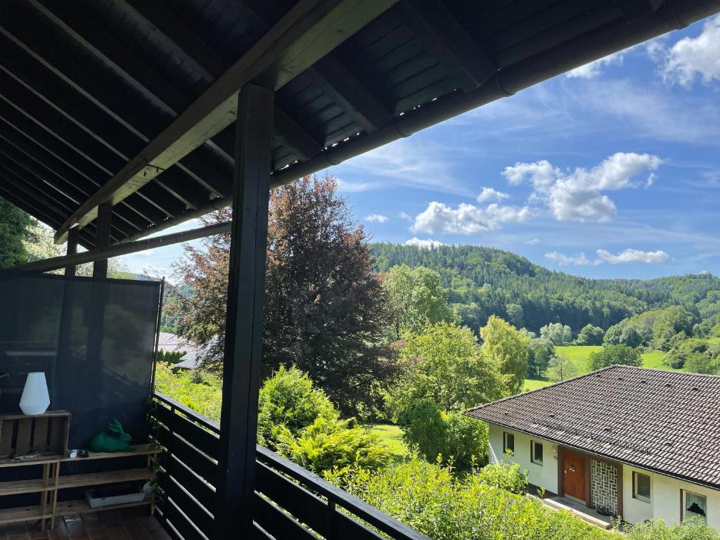 a view from the porch of a house with the mountains in the background at Schlossblick in Egloffstein