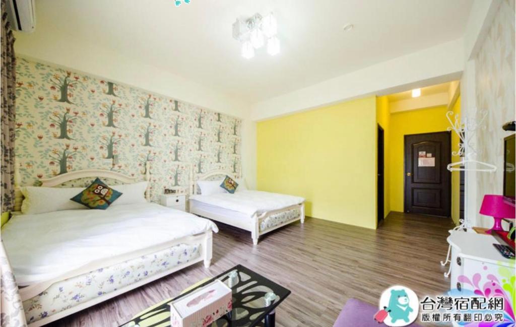 1 dormitorio con 2 camas en una habitación con paredes amarillas en 花漾四季民宿市中心附停車位 自助入住 可包棟, en Hualien City