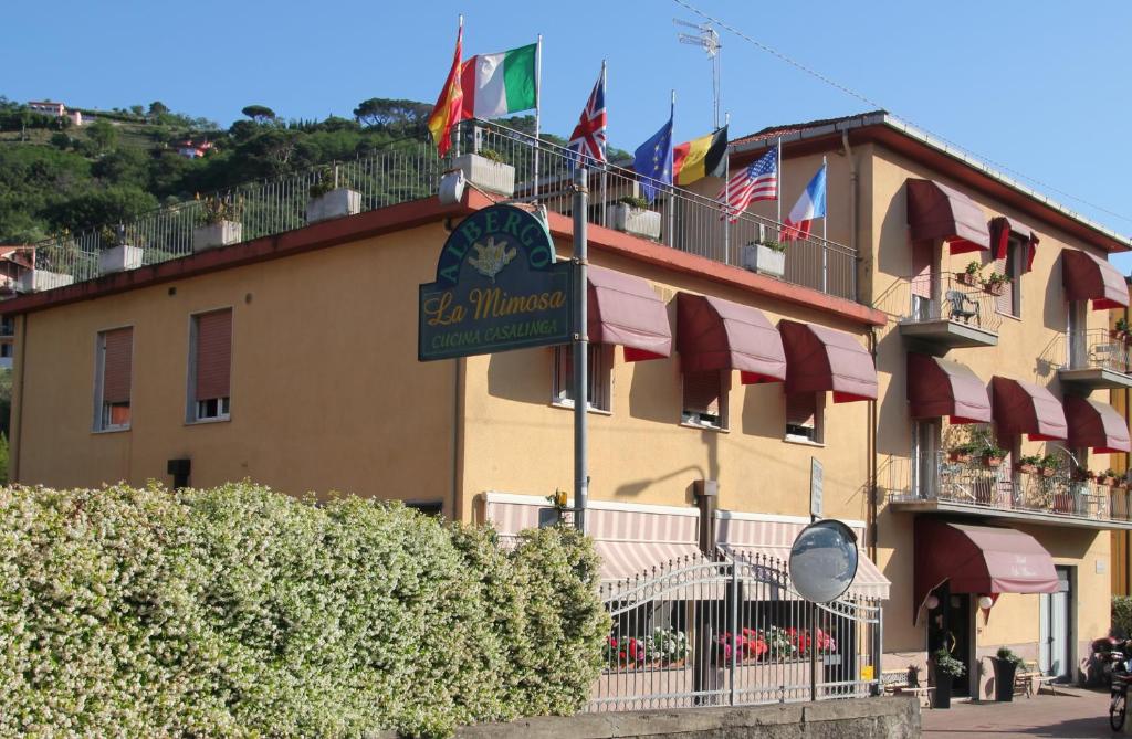 a building with flags on the side of it at Albergo La Mimosa in Lerici