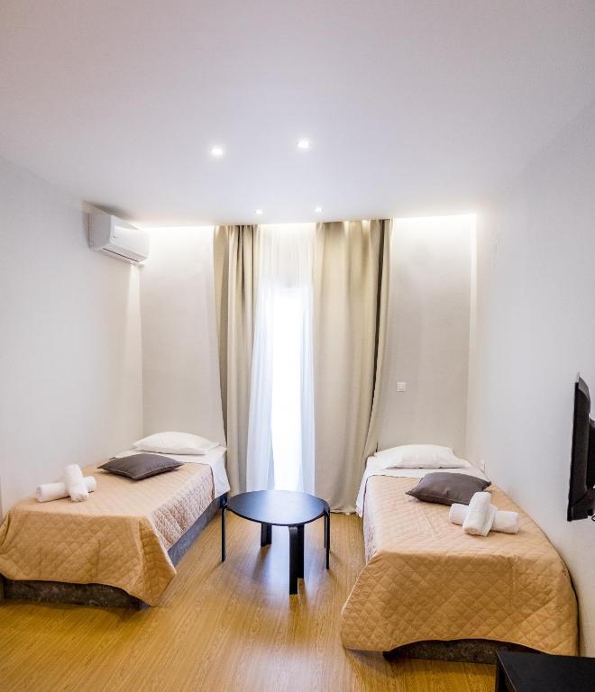 A bed or beds in a room at Evangeline Maisons