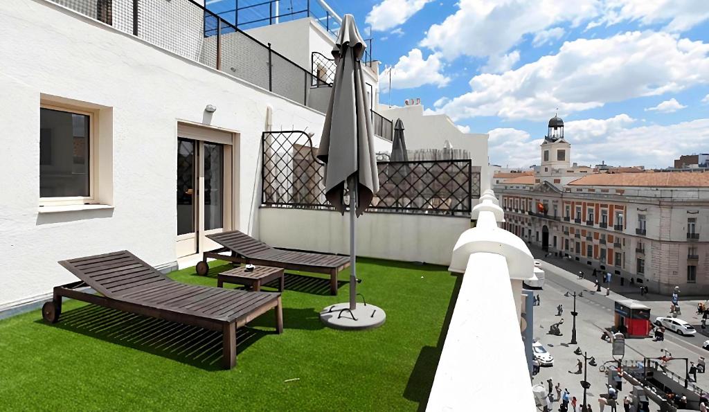 a balcony with benches and a view of a city at Hotel Moderno Puerta del Sol in Madrid