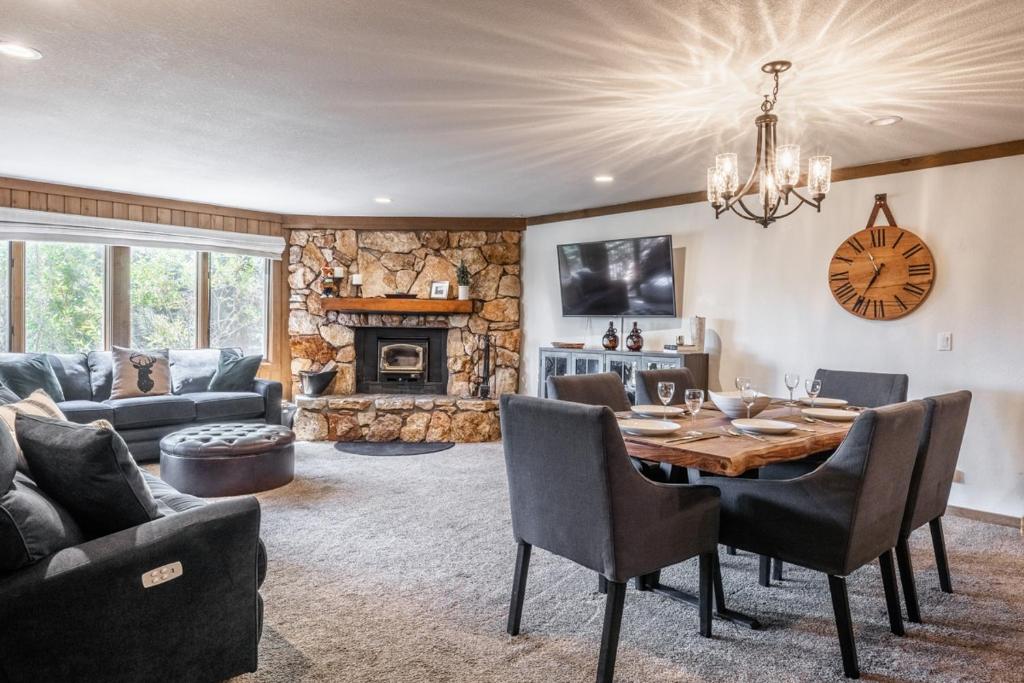 a living room with a table and a fireplace at Mountainback 15 in Old Mammoth