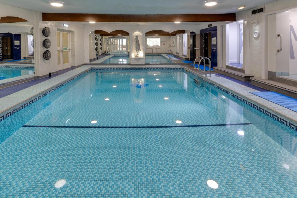 a swimming pool with a person standing in the middle of it at Park Manor Hotel in Scarborough