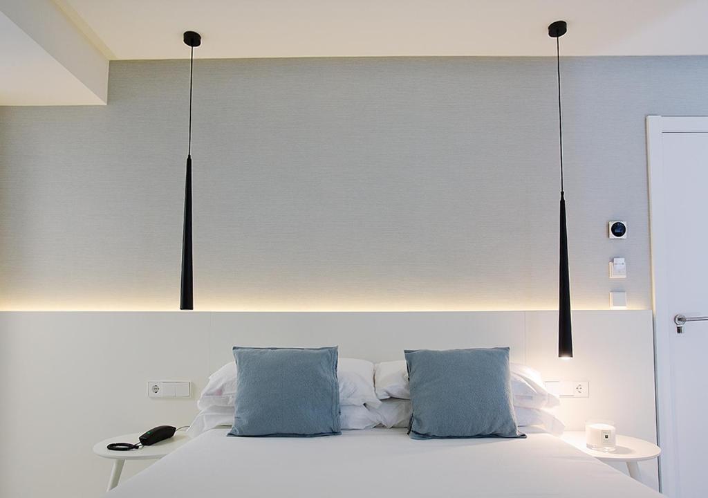 Postel nebo postele na pokoji v ubytování Hotel María Cristina