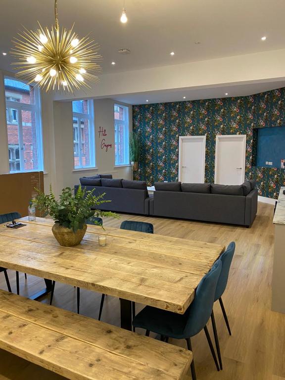 a dining room with wooden tables and a couch at York Riverside Apartments in York