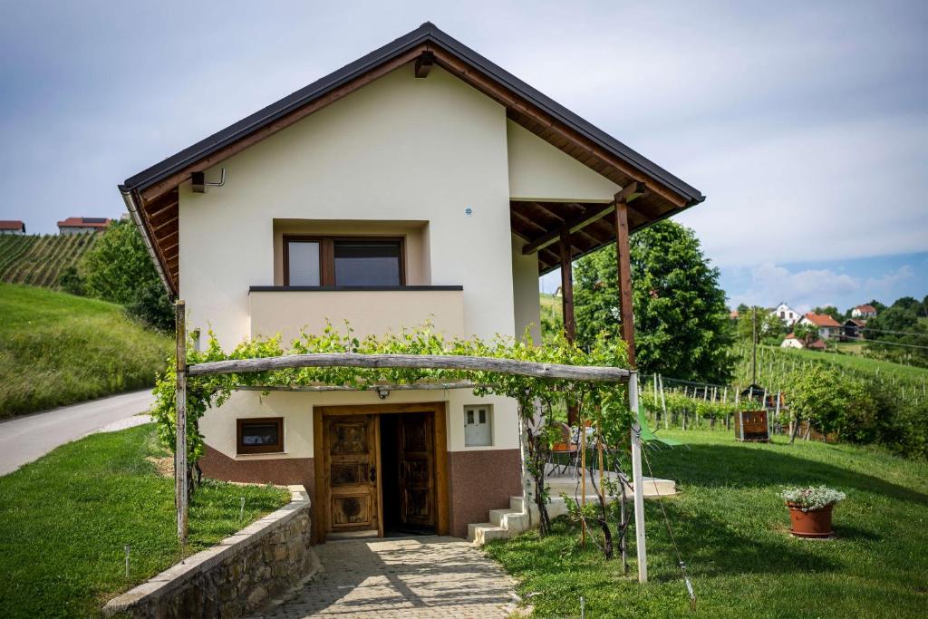 ein kleines Haus mit einem Bogen davor in der Unterkunft Holiday House Zlačka Gorca in Pristava pri Mestinju