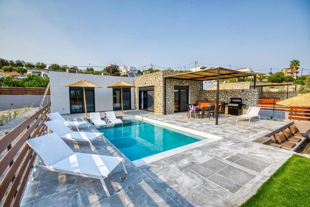 a villa with a swimming pool and a patio at Terra Secreta Luxury Villas in Lartos