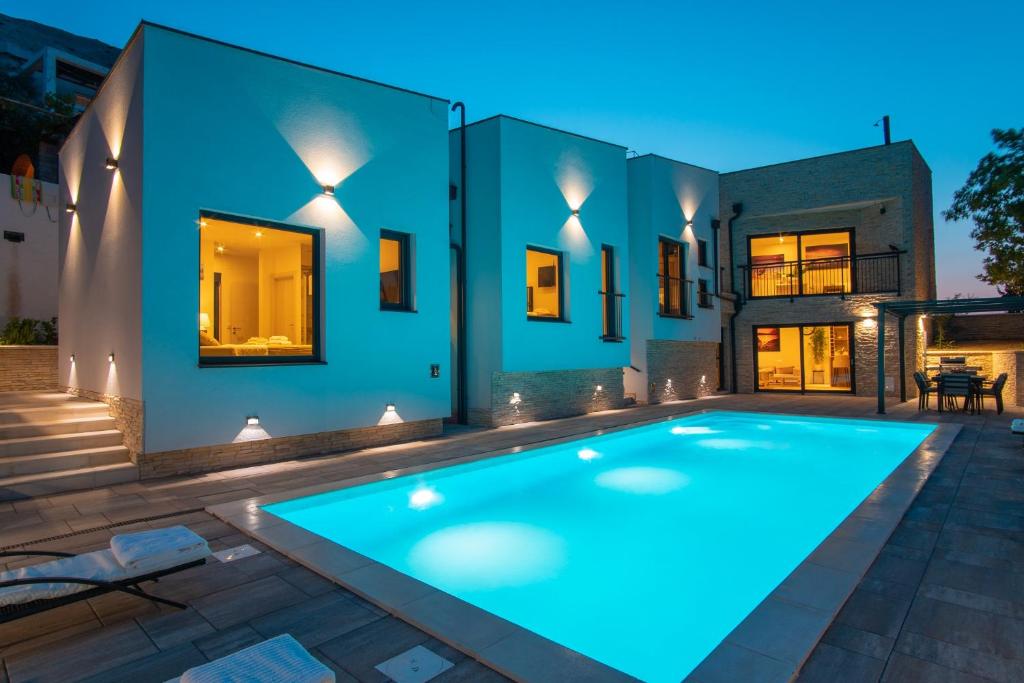 - une piscine dans l'arrière-cour d'une maison la nuit dans l'établissement Perla Nera Heated Pool & Sauna, à Stan Trigraci