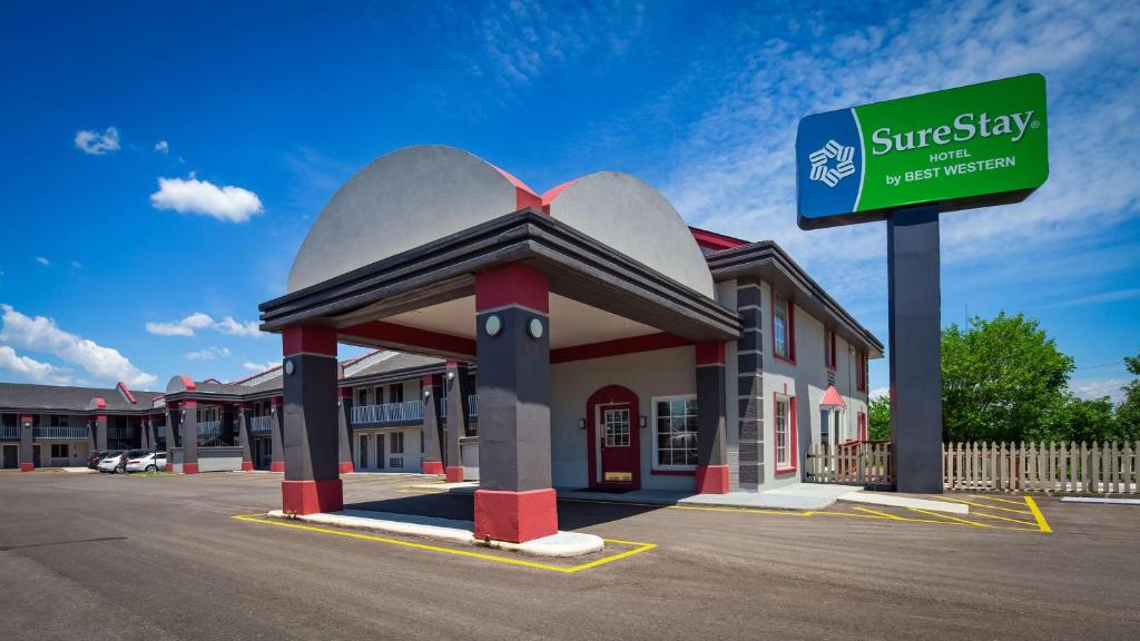 a building with a sign in front of it at SureStay Hotel By Best Western Olathe in Olathe