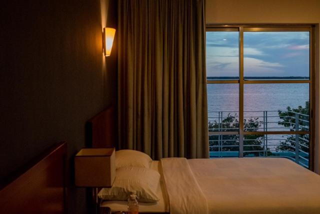 Postel nebo postele na pokoji v ubytování Hotel Noor
