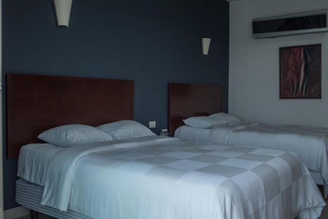 Postel nebo postele na pokoji v ubytování Hotel Noor
