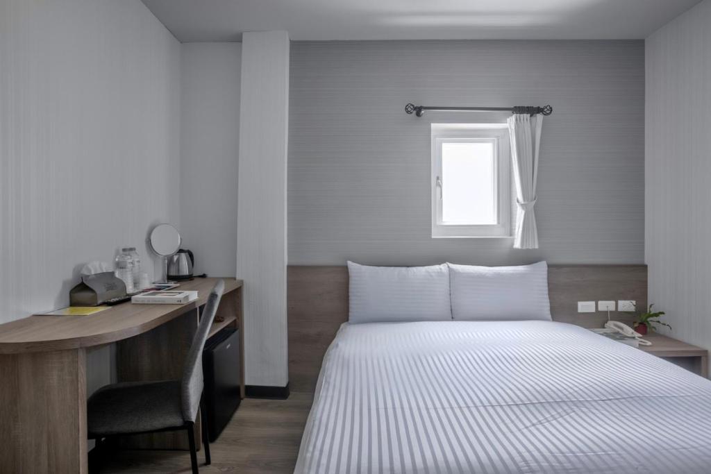 Postel nebo postele na pokoji v ubytování Hotel Brown - Zhongzheng