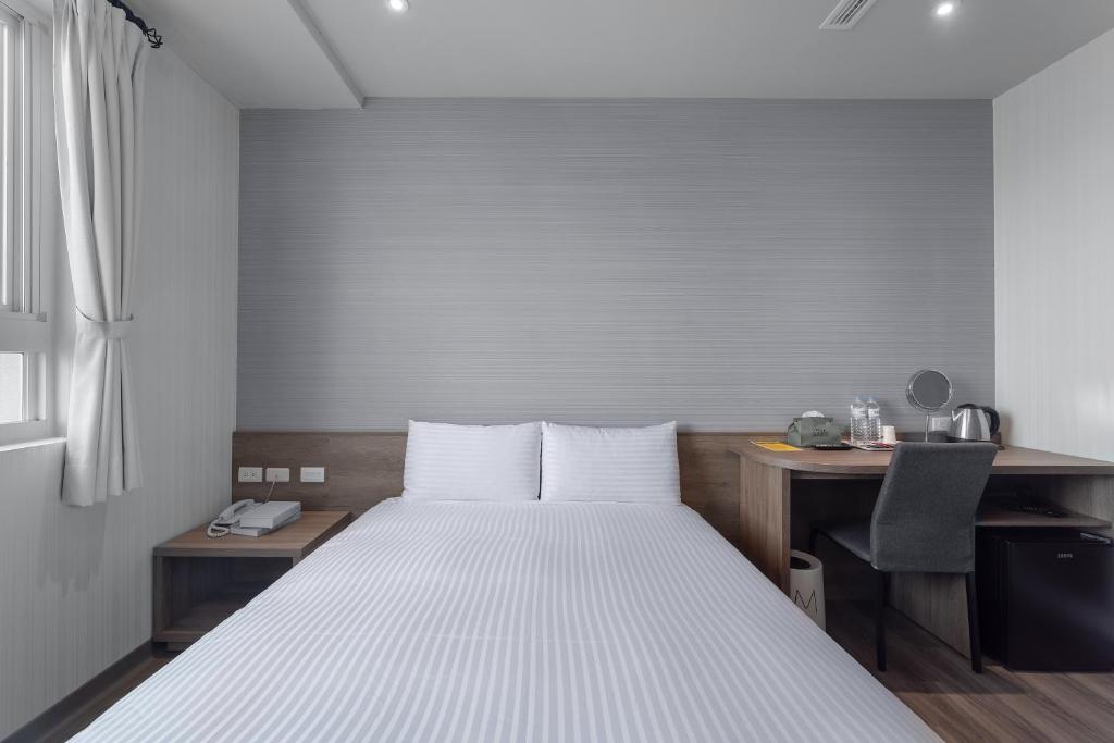 Postel nebo postele na pokoji v ubytování Hotel Brown - Zhongzheng