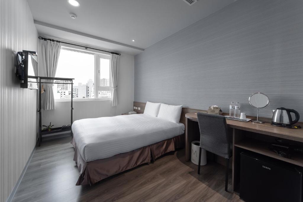 Postel nebo postele na pokoji v ubytování Hotel Brown - Zhongzheng