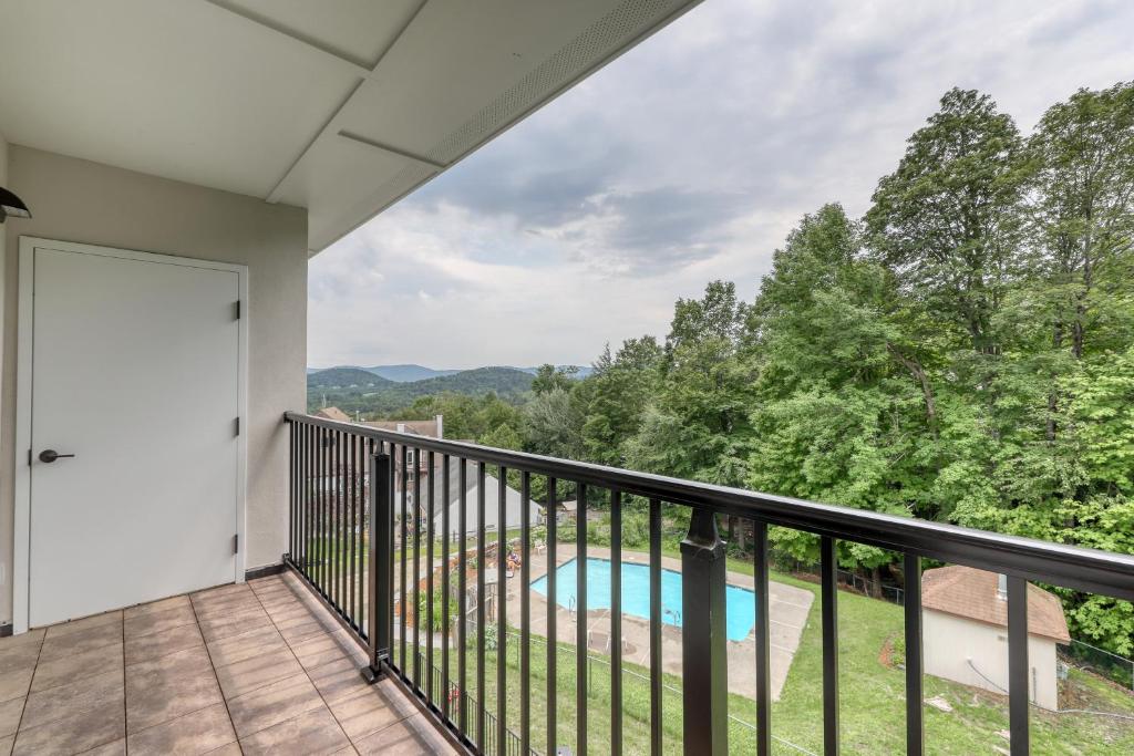 een balkon met uitzicht op een zwembad en de bergen bij Mountainside Dream in Warren