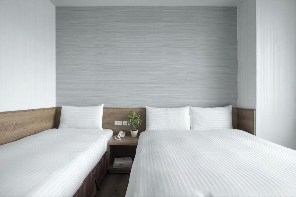 Postel nebo postele na pokoji v ubytování Hotel Brown - Zhongzheng