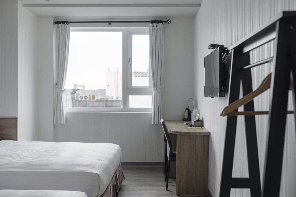 Postel nebo postele na pokoji v ubytování Hotel Brown - Zhongzheng