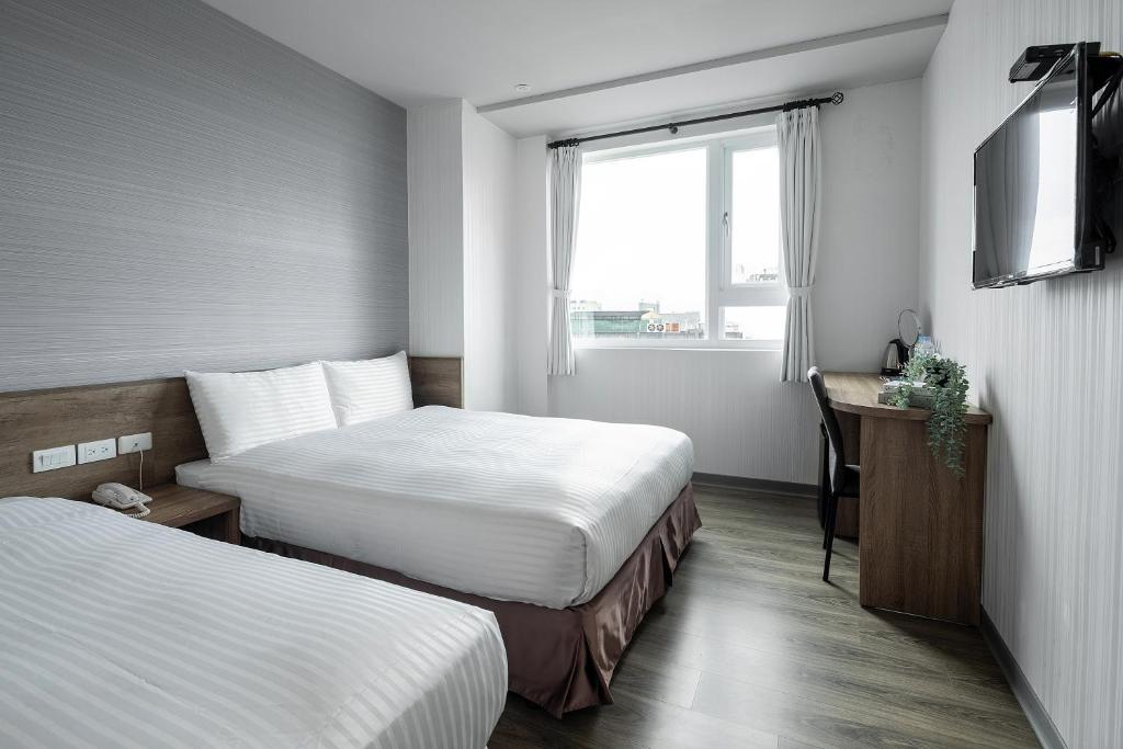 Postel nebo postele na pokoji v ubytování Hotel Brown - Zhongzheng
