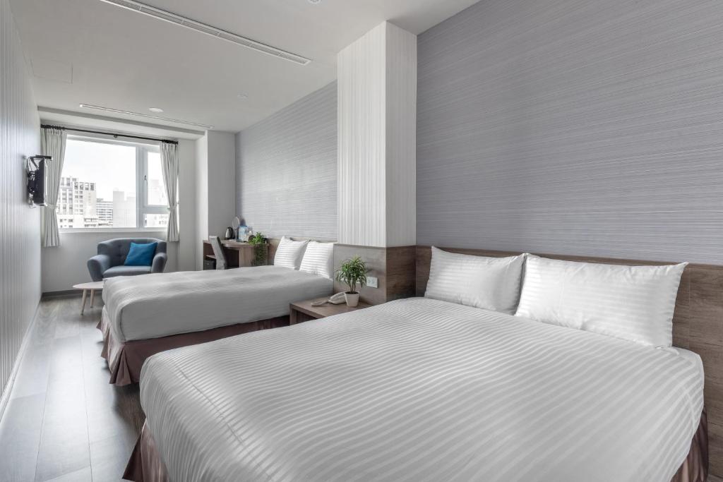 Postel nebo postele na pokoji v ubytování Hotel Brown - Zhongzheng