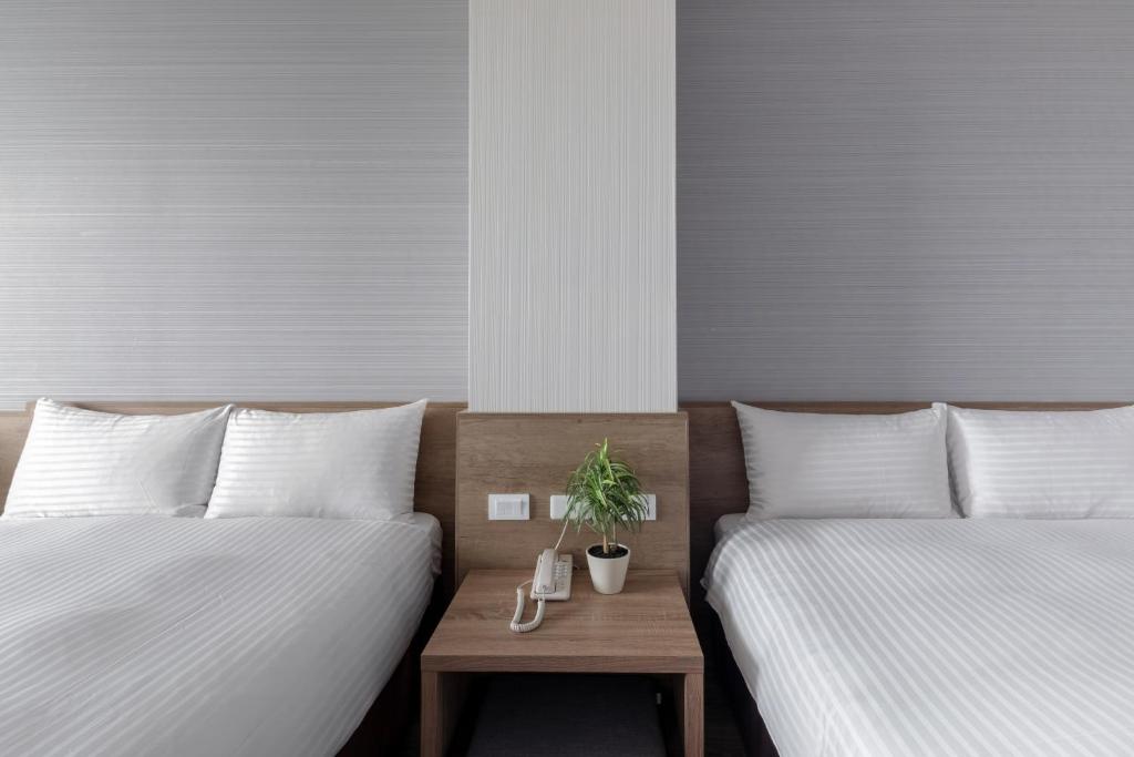 Postel nebo postele na pokoji v ubytování Hotel Brown - Zhongzheng