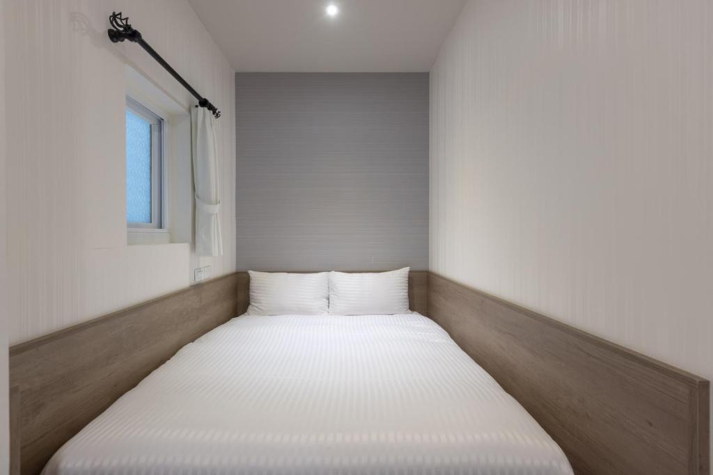 Postel nebo postele na pokoji v ubytování Hotel Brown - Zhongzheng
