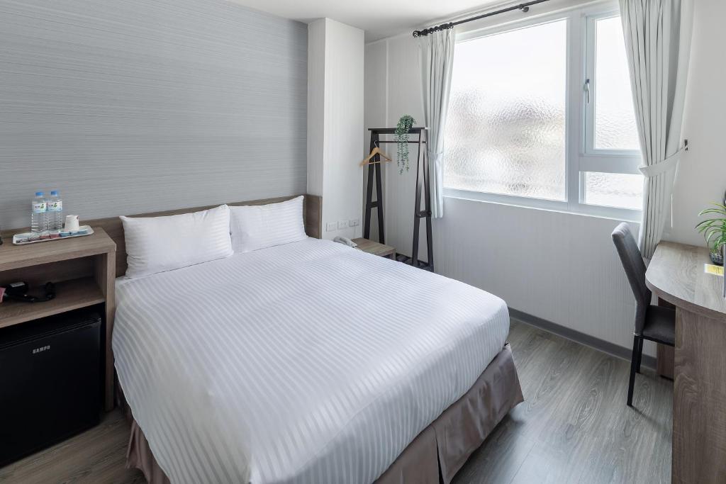 Postel nebo postele na pokoji v ubytování Hotel Brown - Zhongzheng