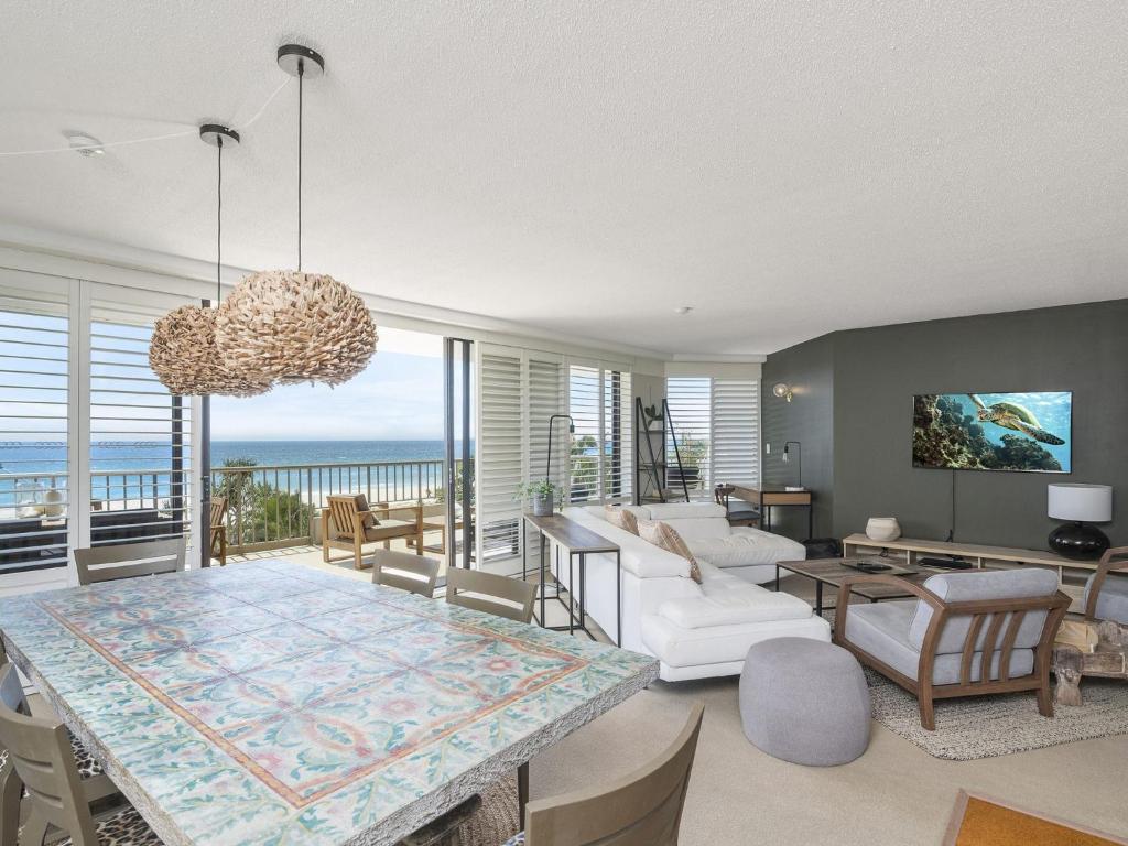 a living room with a table and a view of the ocean at The Rocks Resort Unit 3D in Gold Coast