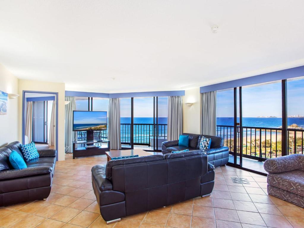a living room with couches and views of the ocean at The Rocks Resort Unit 9J in Gold Coast