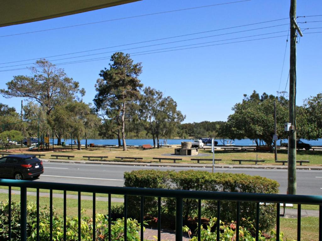 a car driving down a road next to a lake at Riverview Unit 6 in Gold Coast