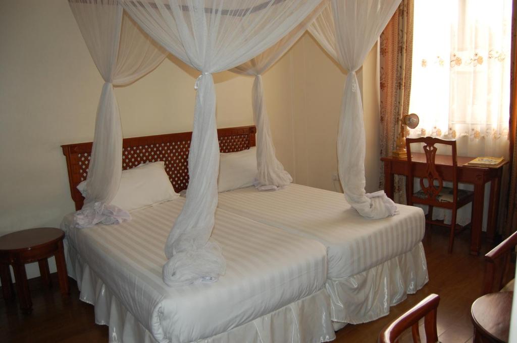 Cama o camas de una habitación en Arusha Tourist Inn Hotel