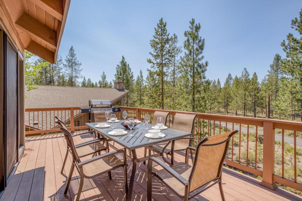 a patio with a table and chairs on a deck at Sunriver Treehouse in Sunriver