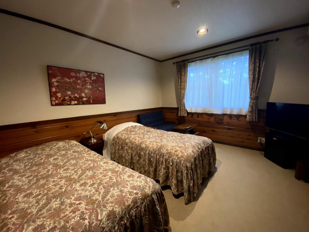 Postel nebo postele na pokoji v ubytování Petit Hotel Kazekozou