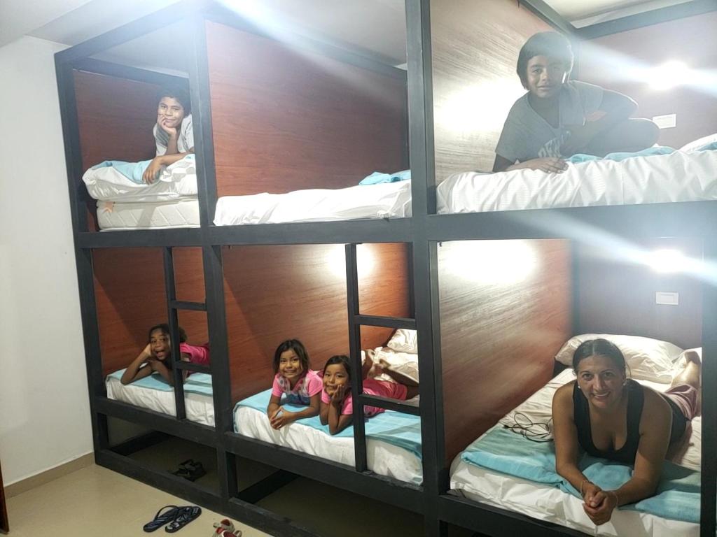 a group of children sitting in bunk beds at Aima Ibagué in Ibagué